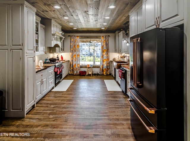 kitchen with white cabinetry, dark hardwood / wood-style floors, and premium appliances