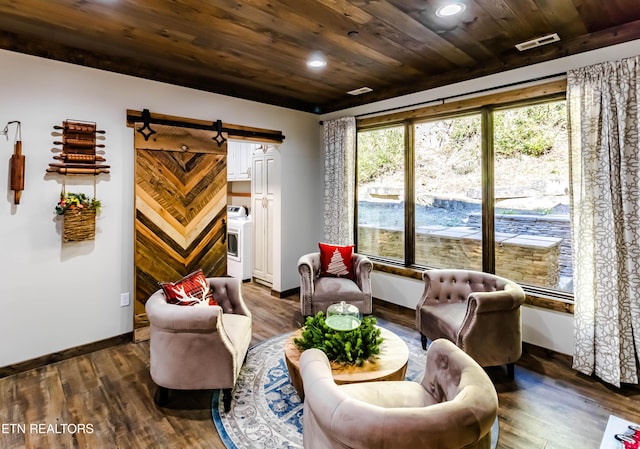 living area with a barn door, dark wood-type flooring, and wooden ceiling