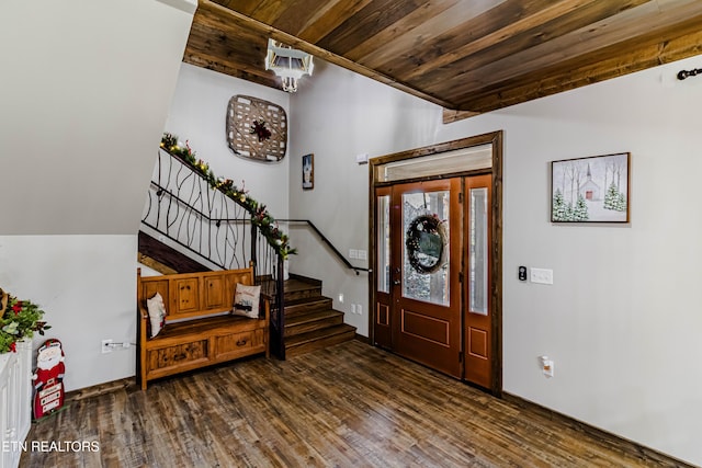 entrance foyer featuring a chandelier, wooden ceiling, and dark hardwood / wood-style flooring