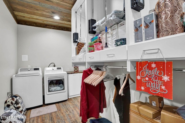 clothes washing area with wood-type flooring, wood ceiling, and washer and clothes dryer