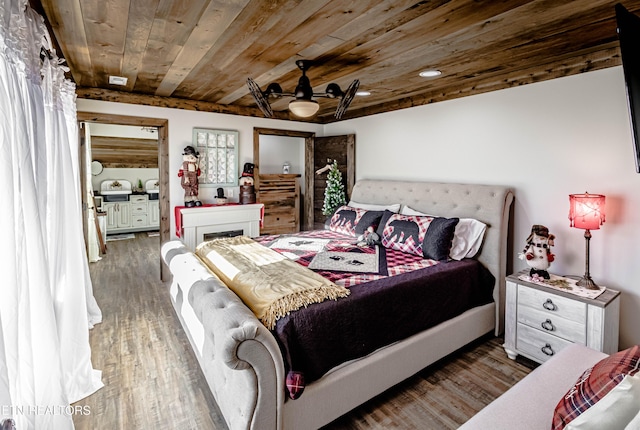 bedroom featuring dark hardwood / wood-style flooring and wooden ceiling