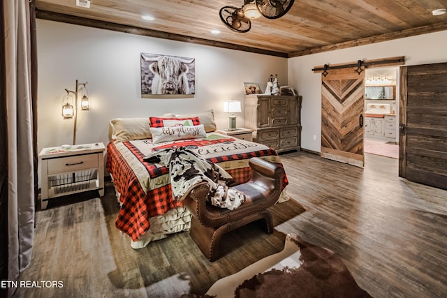 bedroom with wood ceiling, dark hardwood / wood-style floors, a barn door, and ensuite bathroom