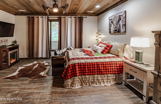 bedroom with dark hardwood / wood-style flooring and wooden ceiling