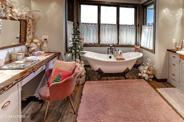 bathroom featuring hardwood / wood-style flooring, vanity, and a bathtub