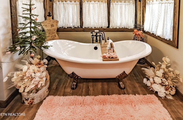 bathroom featuring a washtub and hardwood / wood-style floors