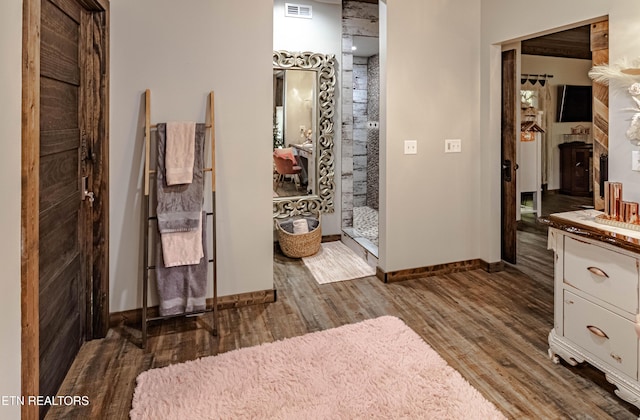 bathroom featuring vanity, wood-type flooring, and an enclosed shower