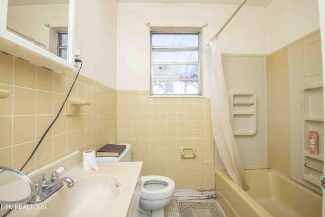 full bathroom featuring tile walls, shower / tub combo, vanity, tile patterned floors, and toilet