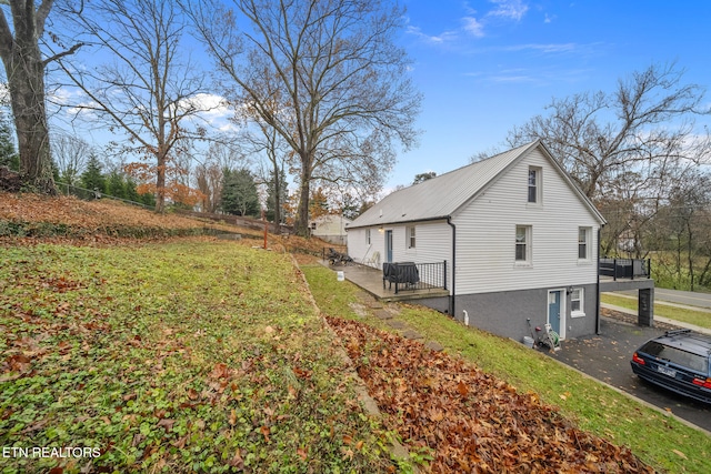 view of property exterior featuring a lawn