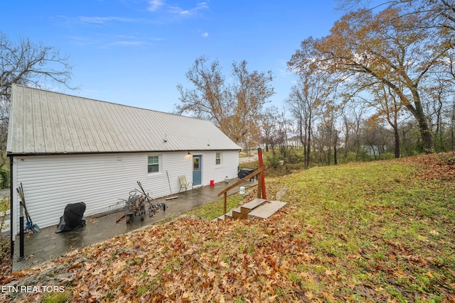 back of property featuring a yard