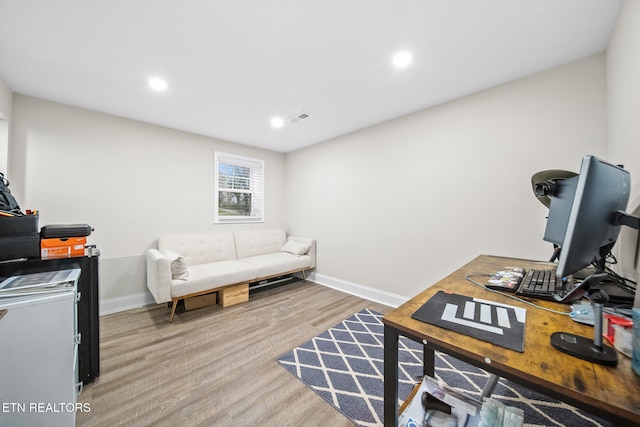 home office with wood-type flooring