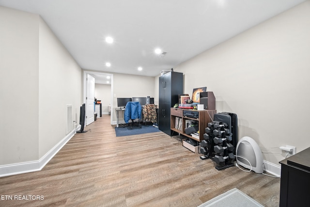 home office with light hardwood / wood-style floors