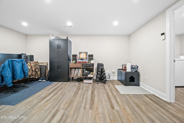 office area featuring washer / dryer and light hardwood / wood-style flooring