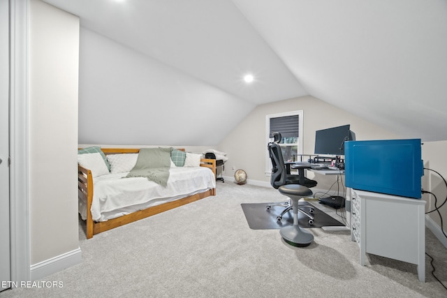 bedroom with vaulted ceiling and light carpet