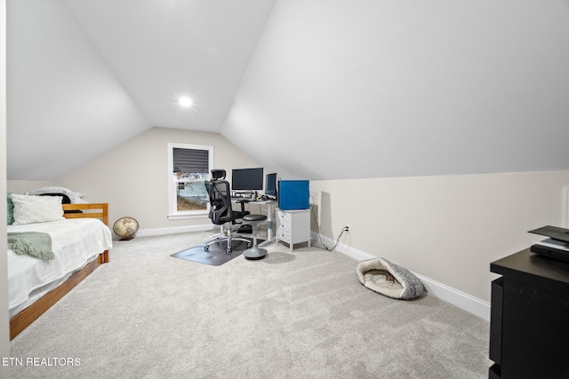 carpeted bedroom with lofted ceiling