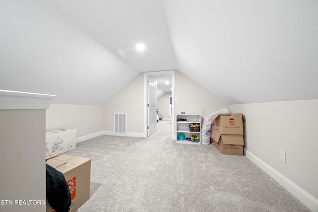 additional living space featuring lofted ceiling and carpet floors