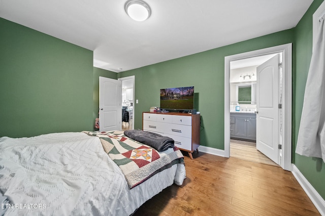 bedroom featuring wood-type flooring and connected bathroom