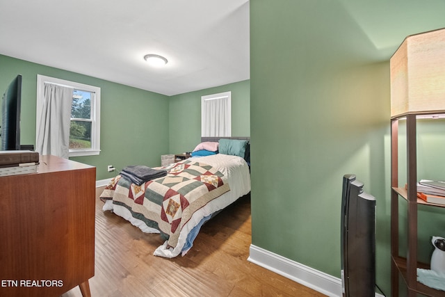 bedroom with hardwood / wood-style flooring