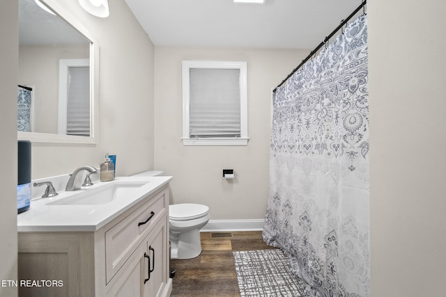 bathroom with vanity, hardwood / wood-style floors, and toilet