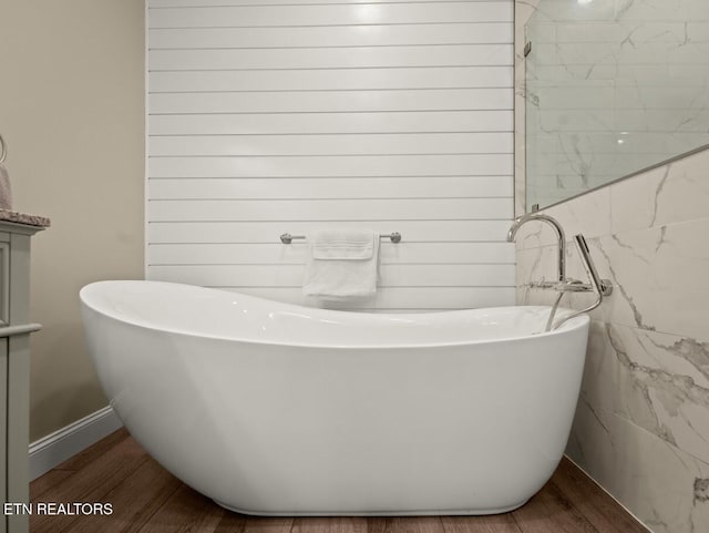 bathroom featuring hardwood / wood-style floors and a bathing tub