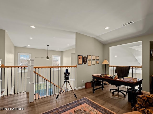 office space featuring hardwood / wood-style floors, vaulted ceiling, and ceiling fan