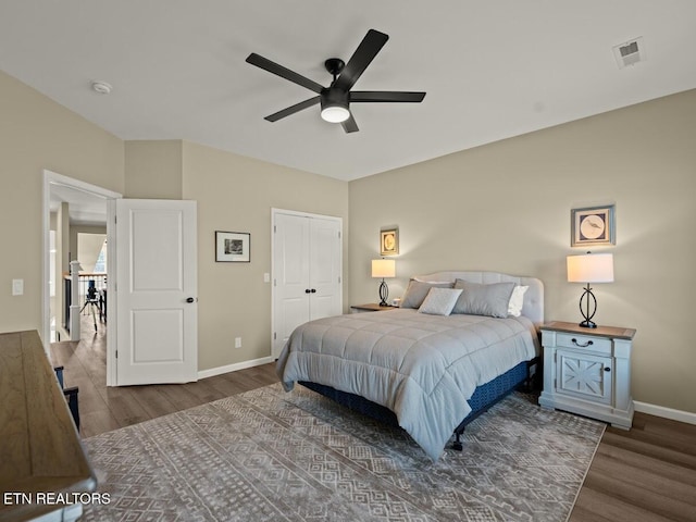 bedroom with ceiling fan, hardwood / wood-style floors, and a closet