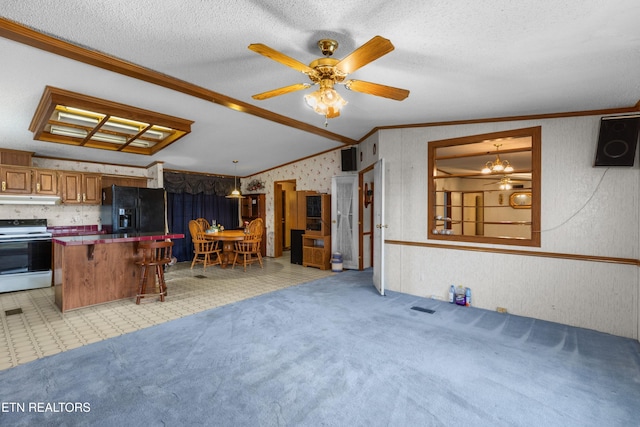 carpeted living room featuring lofted ceiling, crown molding, and a textured ceiling