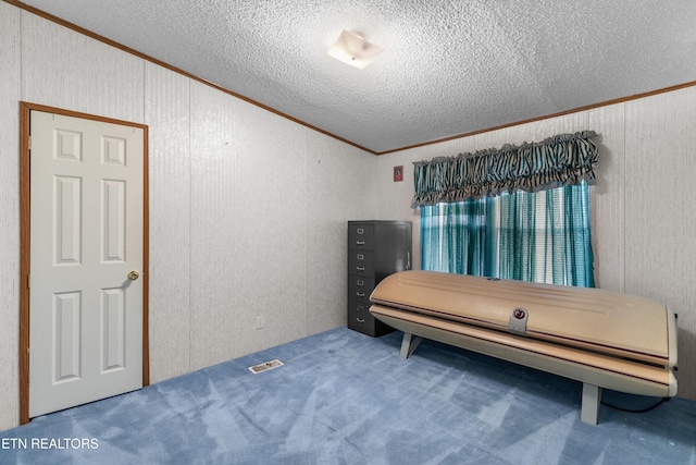 bedroom with ornamental molding and a textured ceiling