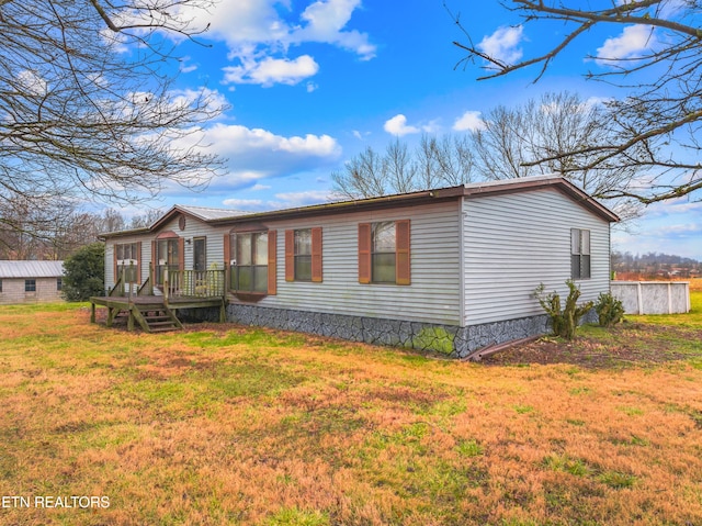 exterior space featuring a wooden deck and a front lawn