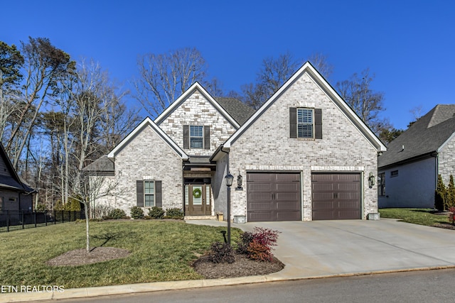 view of front of property featuring a garage and a front lawn