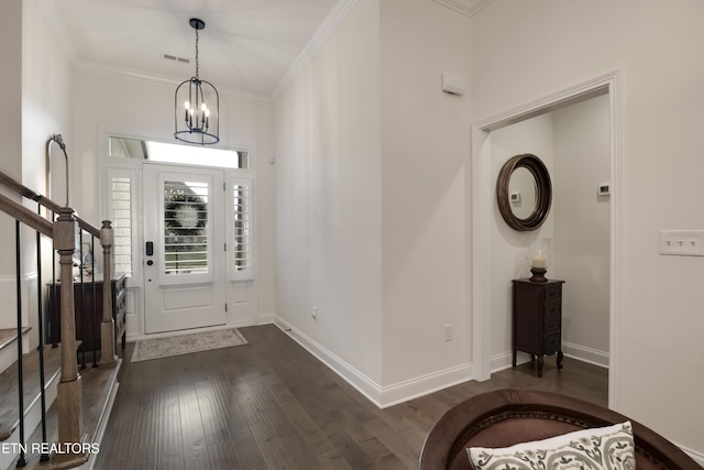 foyer with crown molding, a chandelier, and dark hardwood / wood-style flooring