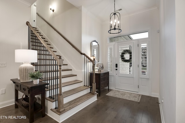 entryway featuring ornamental molding, a chandelier, and dark hardwood / wood-style flooring