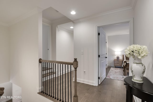 hall with dark wood-type flooring and ornamental molding