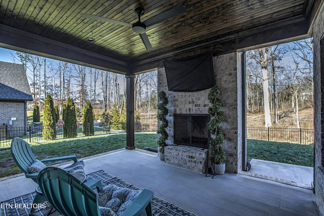 view of patio / terrace featuring an outdoor brick fireplace and ceiling fan