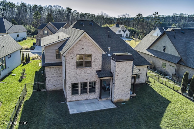 back of property featuring a yard and a patio area