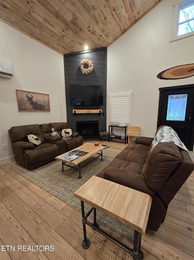 living room with wood ceiling, light hardwood / wood-style floors, and a wall mounted AC