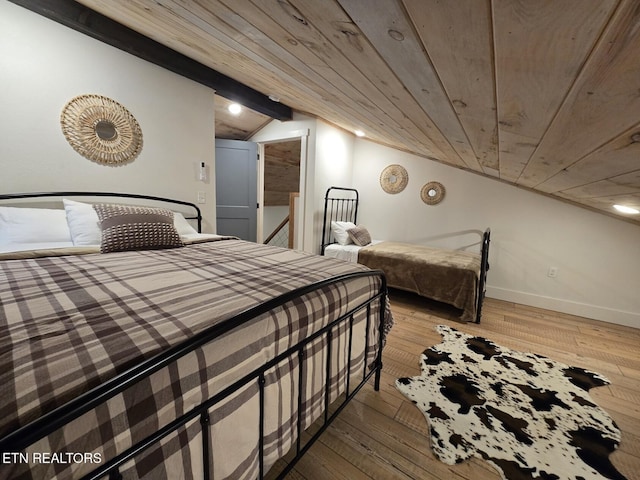 bedroom featuring wood ceiling, vaulted ceiling, and wood-type flooring