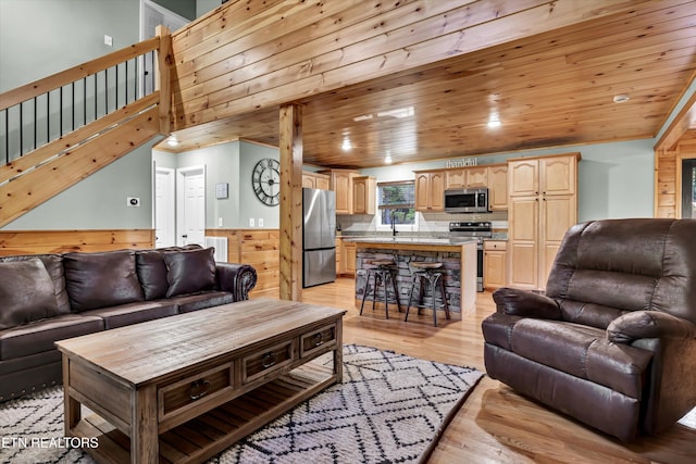 living room featuring sink, wood ceiling, and light hardwood / wood-style flooring