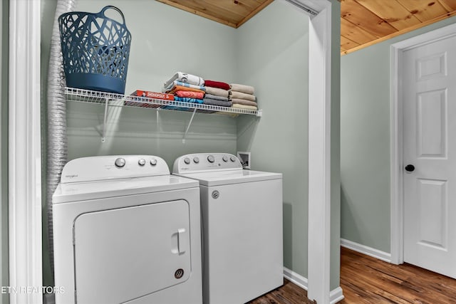 clothes washing area with dark hardwood / wood-style floors, wooden ceiling, and independent washer and dryer