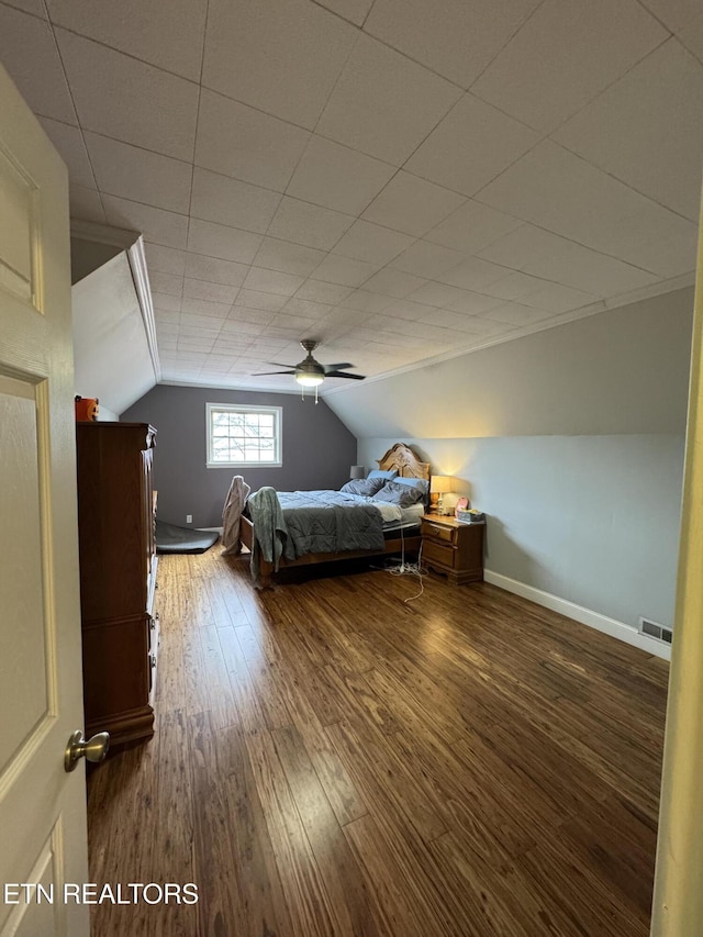 unfurnished bedroom featuring hardwood / wood-style floors, vaulted ceiling, and ceiling fan