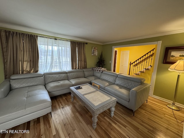 living room with hardwood / wood-style flooring and crown molding