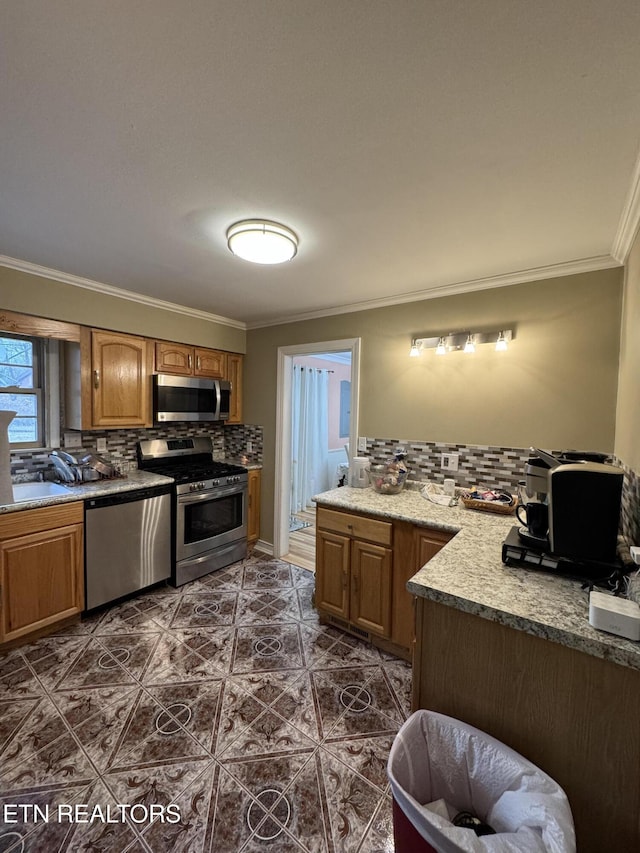 kitchen featuring stainless steel appliances, crown molding, sink, and backsplash