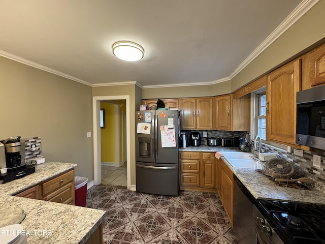 kitchen featuring ornamental molding, appliances with stainless steel finishes, sink, and backsplash