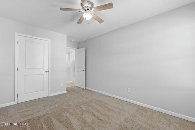 unfurnished bedroom with light colored carpet and ceiling fan