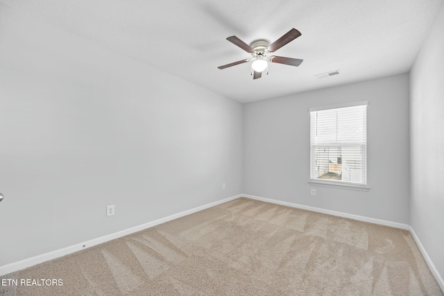 empty room featuring light carpet and ceiling fan