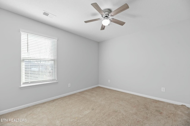 carpeted spare room with ceiling fan