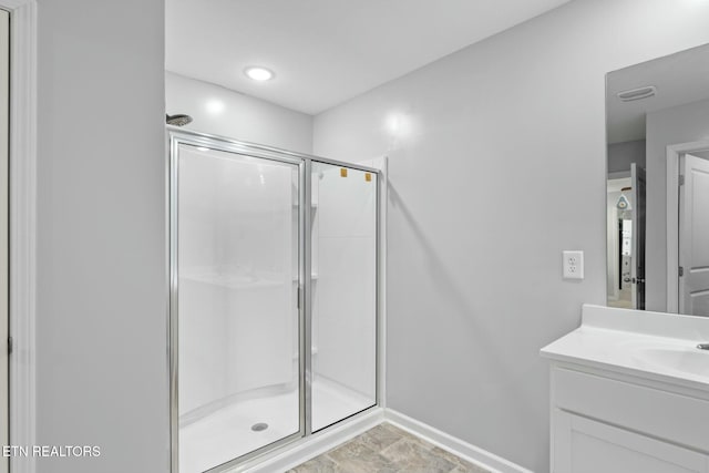 bathroom with vanity and a shower with shower door