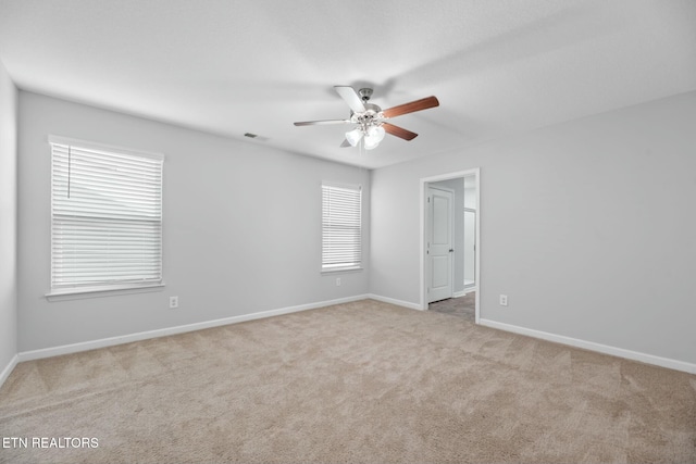 carpeted empty room with ceiling fan