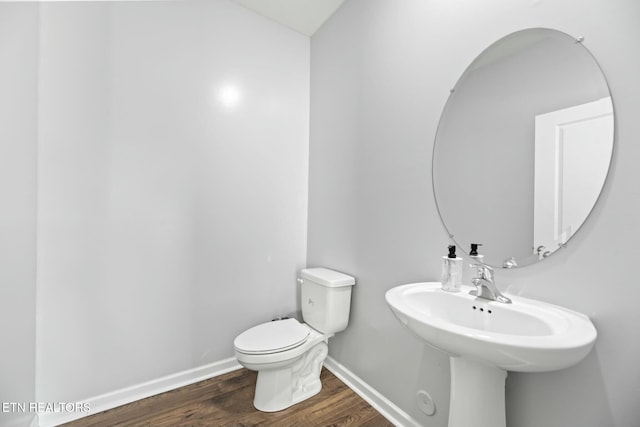 bathroom with sink, wood-type flooring, and toilet