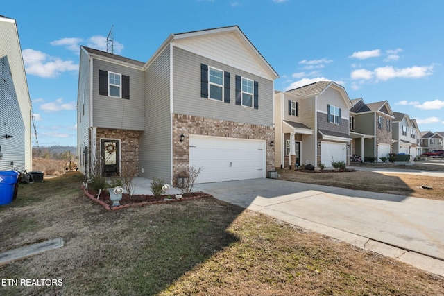 townhome / multi-family property featuring a garage and a front lawn