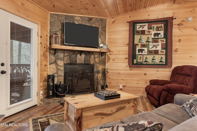 living room with lofted ceiling, hardwood / wood-style flooring, wooden walls, and wooden ceiling